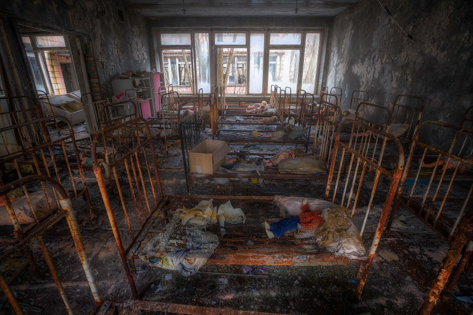 Abandoned dolls lie on rows of children’s beds in Pripyat