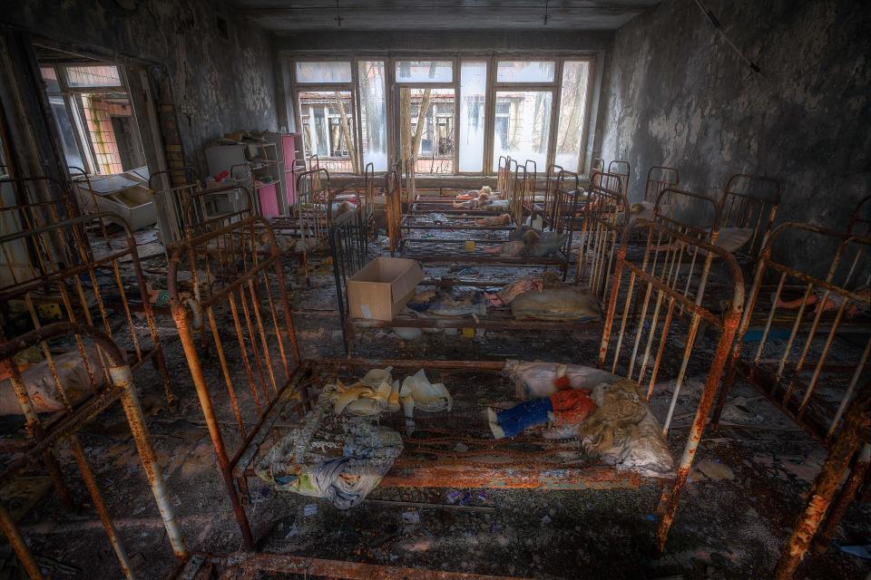  Abandoned dolls lie on rows of children's beds in Pripyat