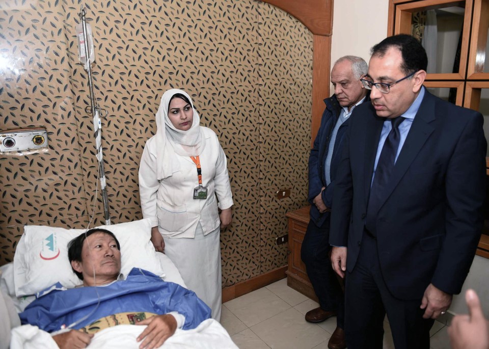 Egypt’s Prime Minister Moustafa Madbouly, right, visiting a Vietnamese tourist injured at a hospital after a bomb explosion, near Mariottia Corridor, Giza