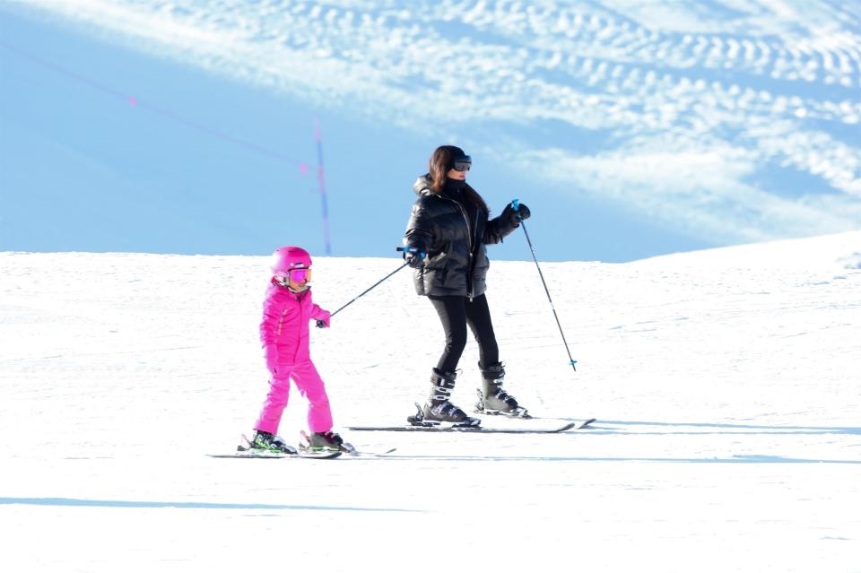  The five-year-old got a little lift from mum Kim's ski pole