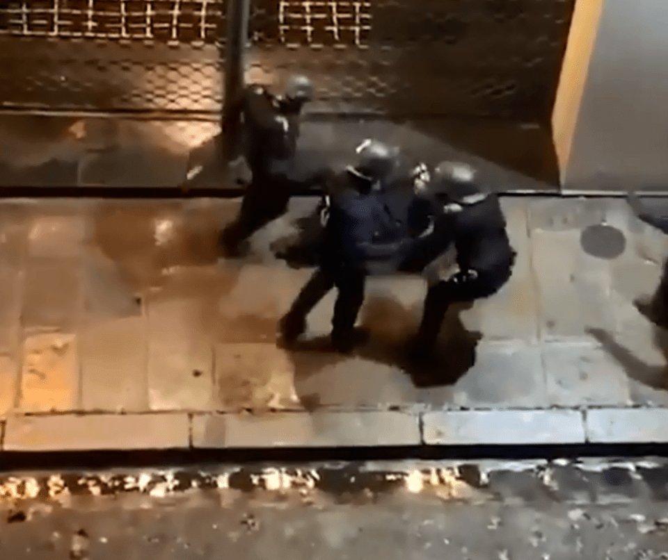  A protester is beaten on the streets of Paris by riot police on Saturday