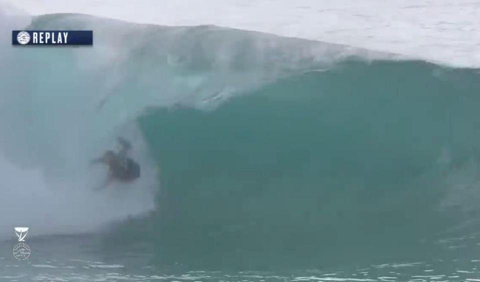 Slater is thrown off his board by the sheer force of the huge wave