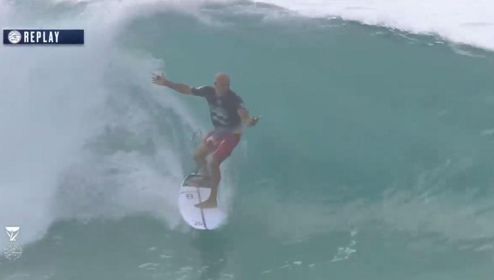 The 'undisputed king of surfing' then gets into the standing position 