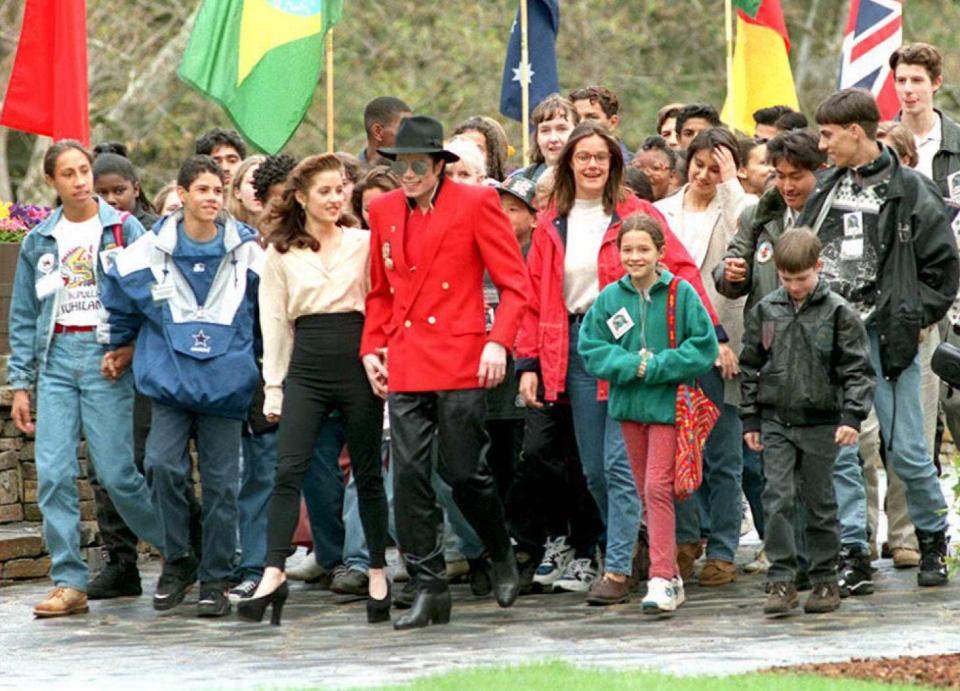  The pop superstar holds hands with his then wife Lisa Marie Presley, walks with children at his Neverland Ranch