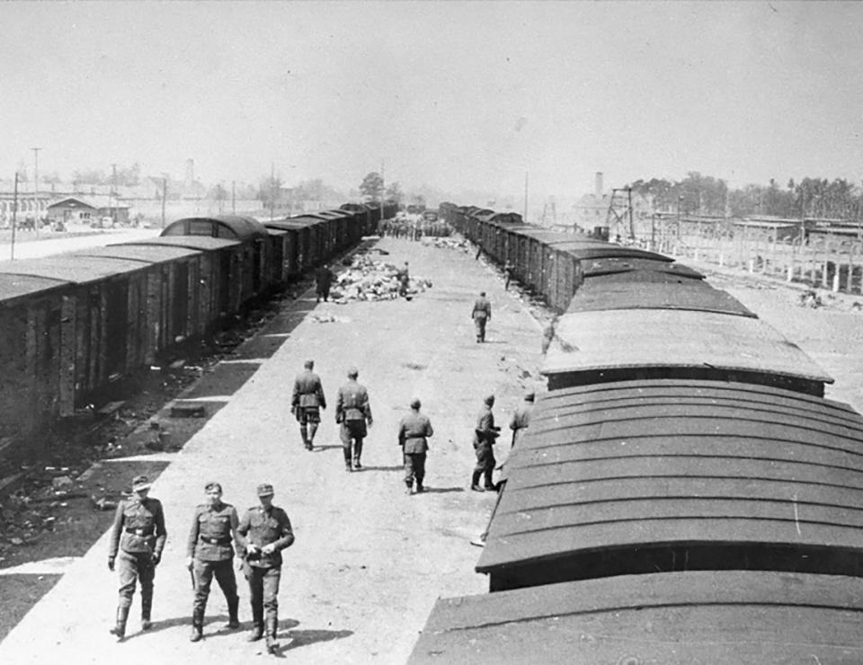  SS guards walking along the arrival camp at the Auschwitz-Birkenau death camp in German-occupied Poland