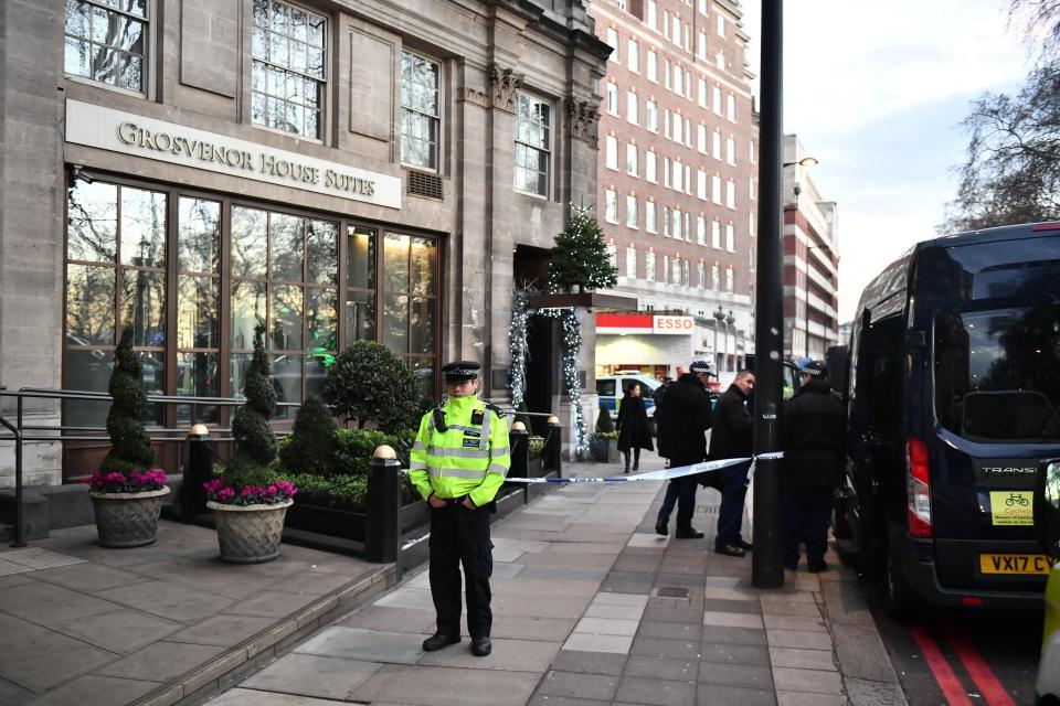  Police stand guard outside the cordon close to the exclusive Grosvenor House Suites