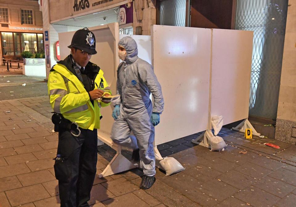  Forensics officers at the scene of the attack as police hunt for those responsible