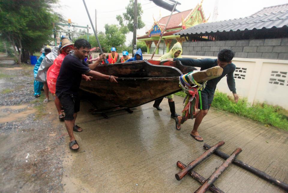  Locals across the country also braced for the storm and seen here attempting to move fishing boats to safety