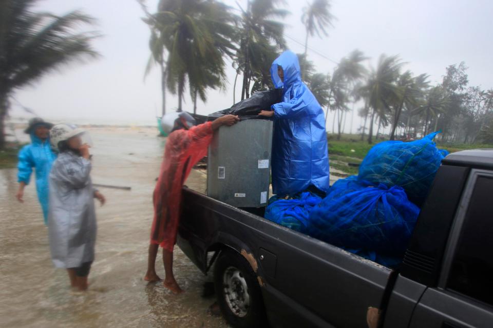  Locals attempted to get their belongings to safety as the harsh weather swooped in