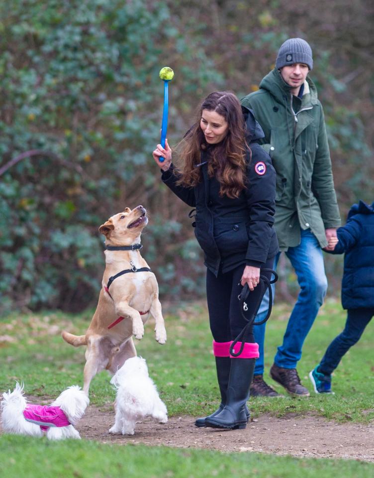  The 44-year-old looked happy as she  threw a tennis ball for the pooches