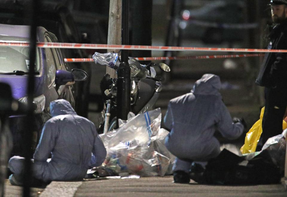  Forensic officers work at the scene. Police have launched a probe into the teen's death