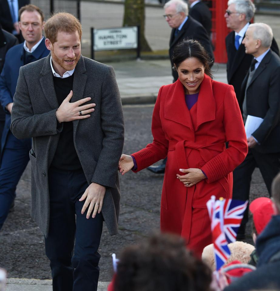 Prince Harry, Duke of Sussex (L) and Meghan, Duchess of Sussex greet wellwishers as they visit Birkenhead, northwest England