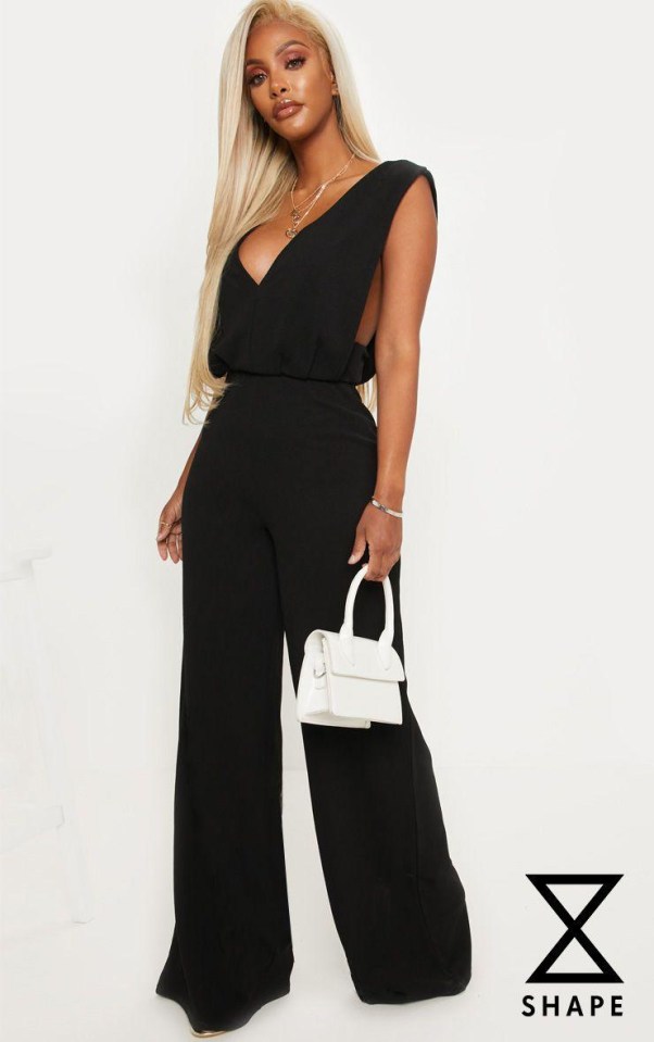 On the model, the jumpsuit appears to be made from a loose fabric with black straps draped across her arms