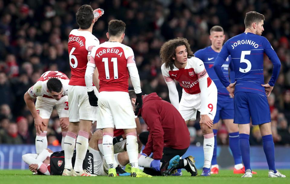 Arsenal and Chelsea stars alike look concerned for Hector Bellerin