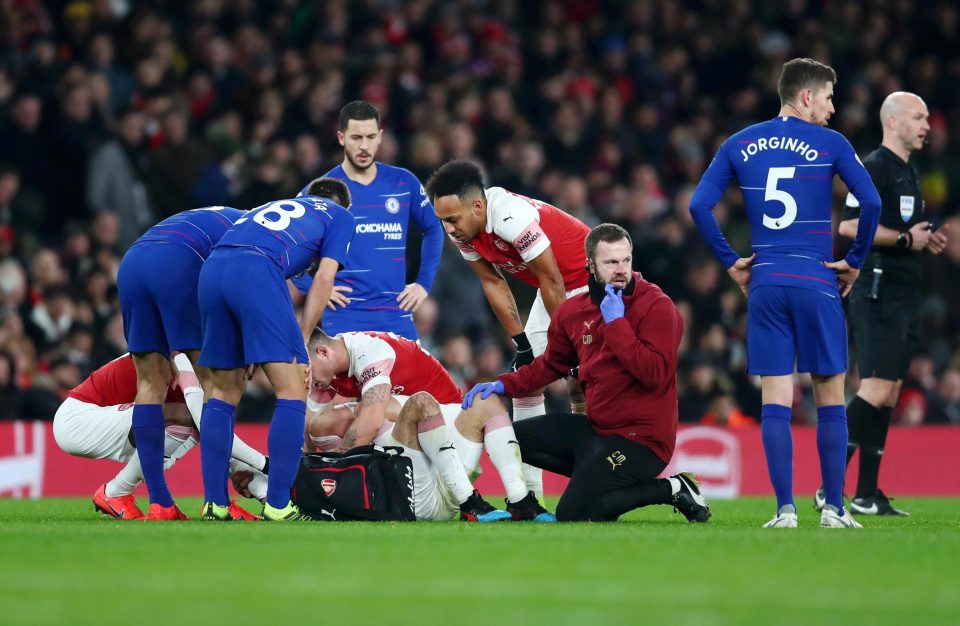 A medic treats Hector Bellerin after he suffers a horror leg injury