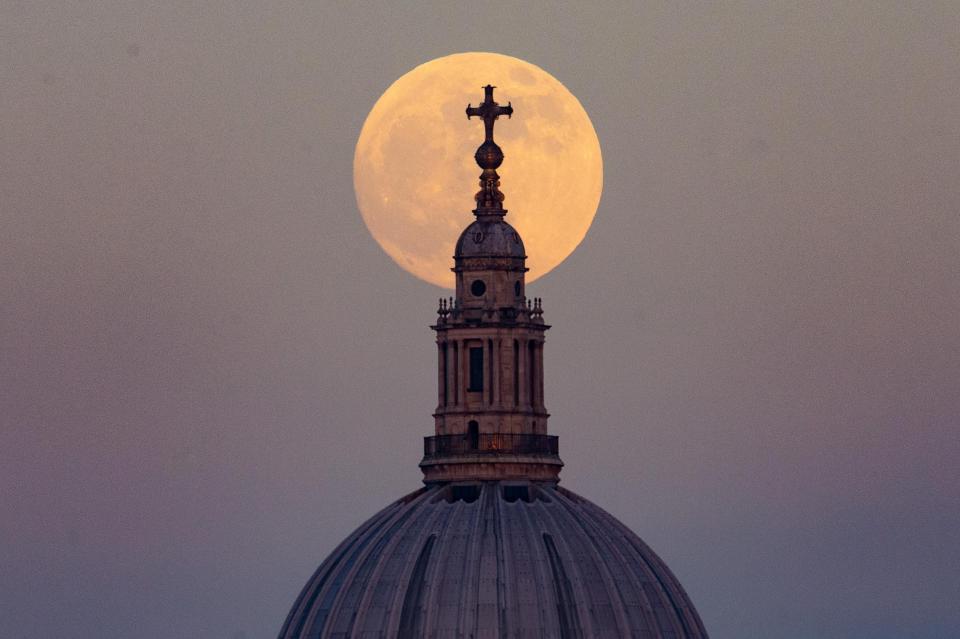  The 'Blood Moon' rises behind St Paul's Cathedral in London ahead of its eclipse in the early morning, viewed from Hungerford Bridge on the River Thames, January 20