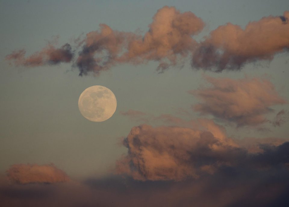  A full moon rises over Rosarito Reservoir near Oropesa, in Toledo province, Spain