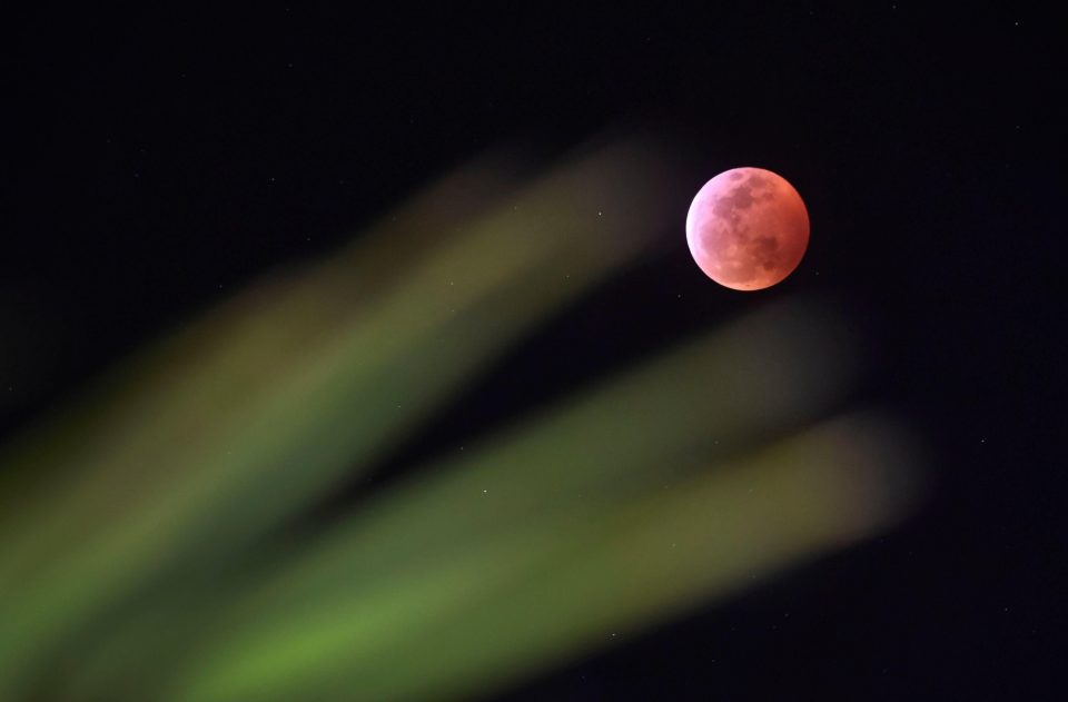  The Earth's shadow almost totally obscures the view of the Super Blood Wolf Moon during a total lunar eclipse in Las Vegas