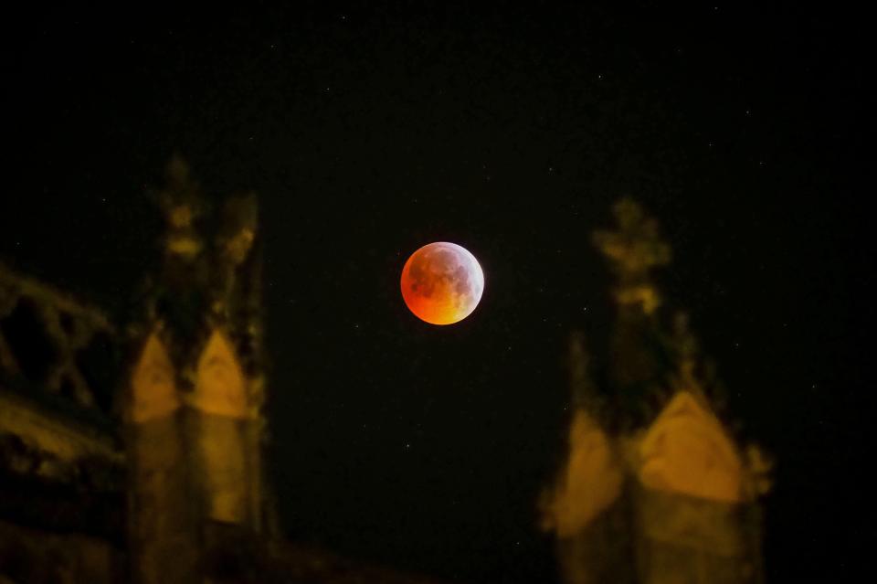  The so-called Super Blood Wolf Moon slips into Earth's dark umbral shadow behind the Tours's cathedral in Indre-et-Loire, France