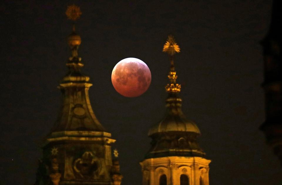  The moon hangs red in the sky in Prague, the Czech Republic