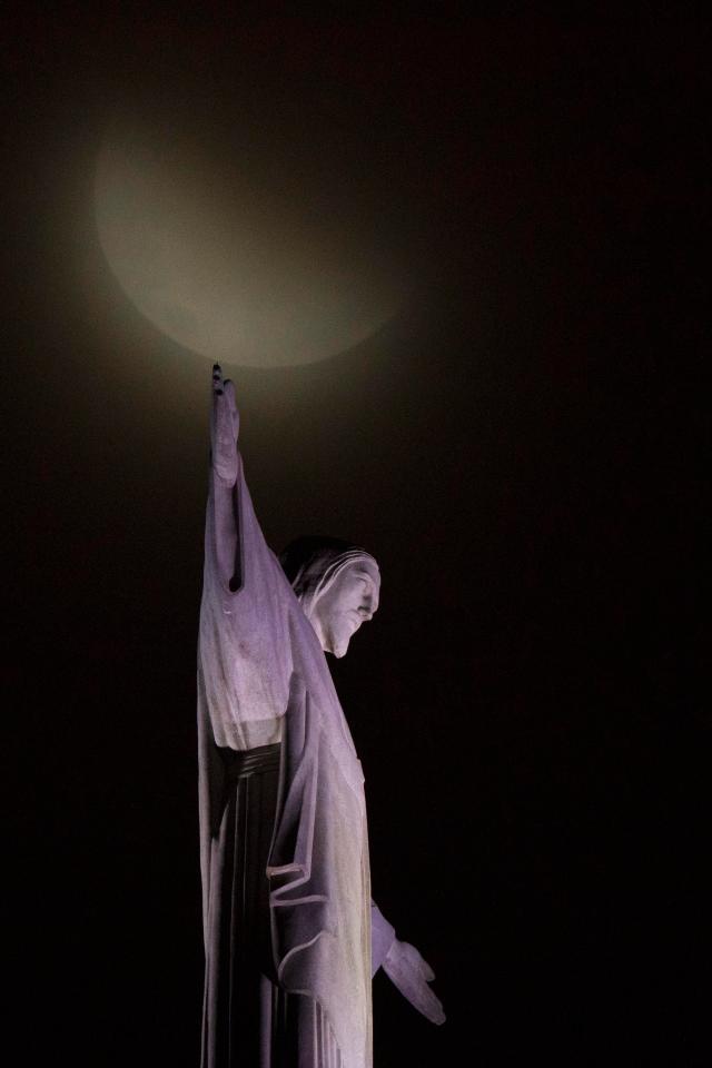  A blood moon rises above Christ the Redeemer statue during a lunar eclipse in Rio de Janeiro, Brazil