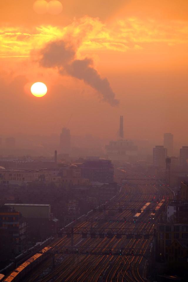  Burnt orange paints the skies as the sun rises in East London this morning