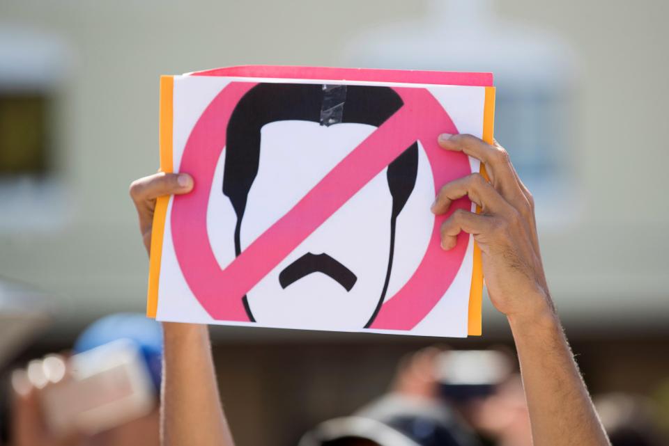  Venezuelans hold a sign during a protest called by the Venezuelan community against President Maduro, in Santo Domingo, Dominican Republic, 23 January 2019