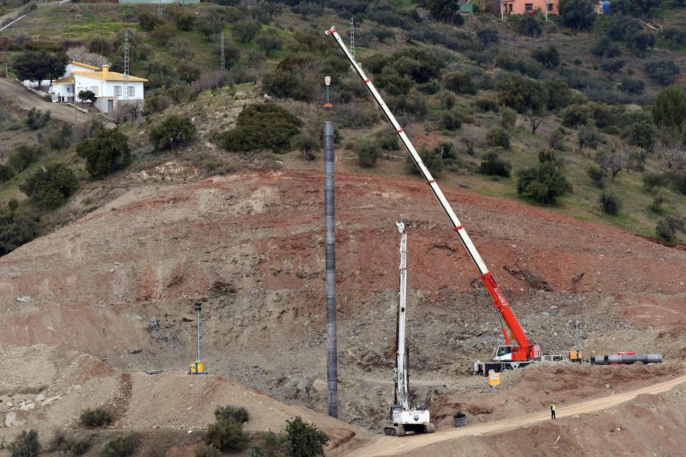  Cranes and diggers take part in the rescue works at the site where a child fell down a well in Totalan