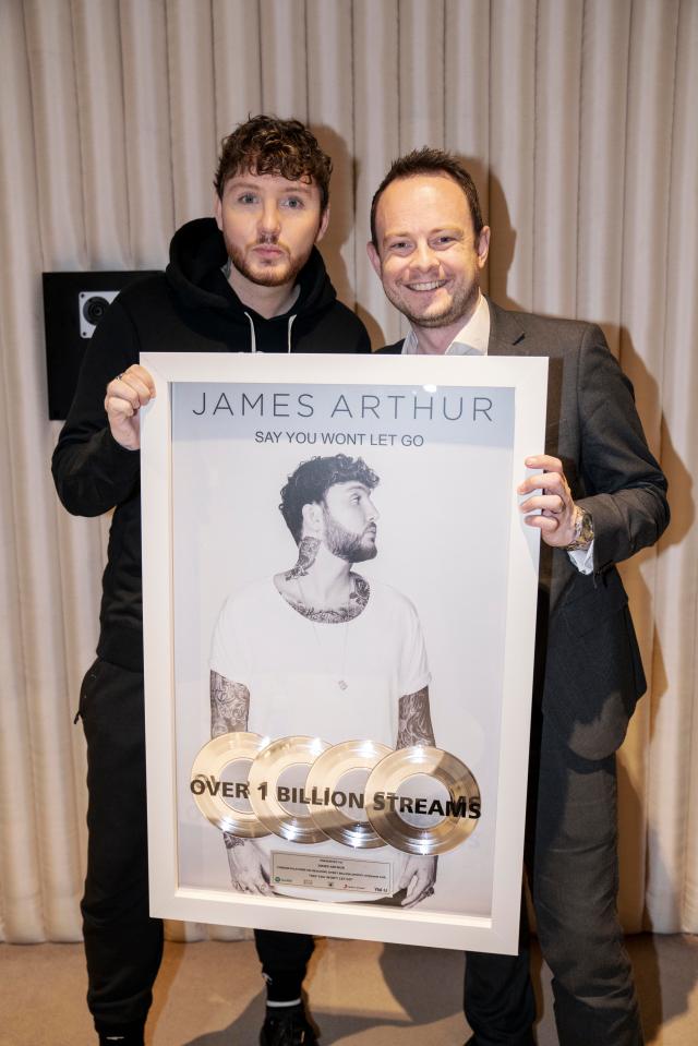  Simon Boyle presents James Arthur with a plaque to mark racking up One Billion streams on Spotify for his hit Say You Won’t Let Go