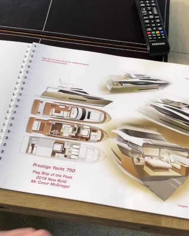  Conor McGregor flicks through the brochure for his new yacht