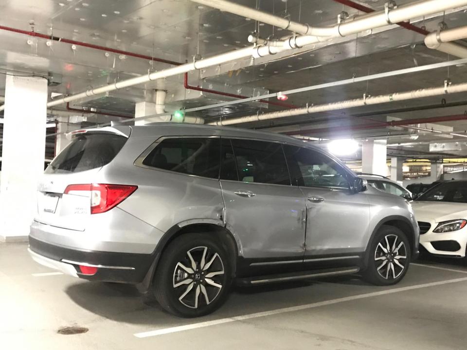 Coleen's old Honda 4x4 with a large dent down the right-hand side