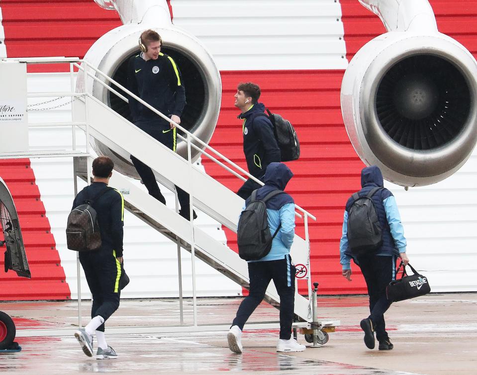  Kevin De Bruyne chats to John Stones while boarding their plane on Tuesday