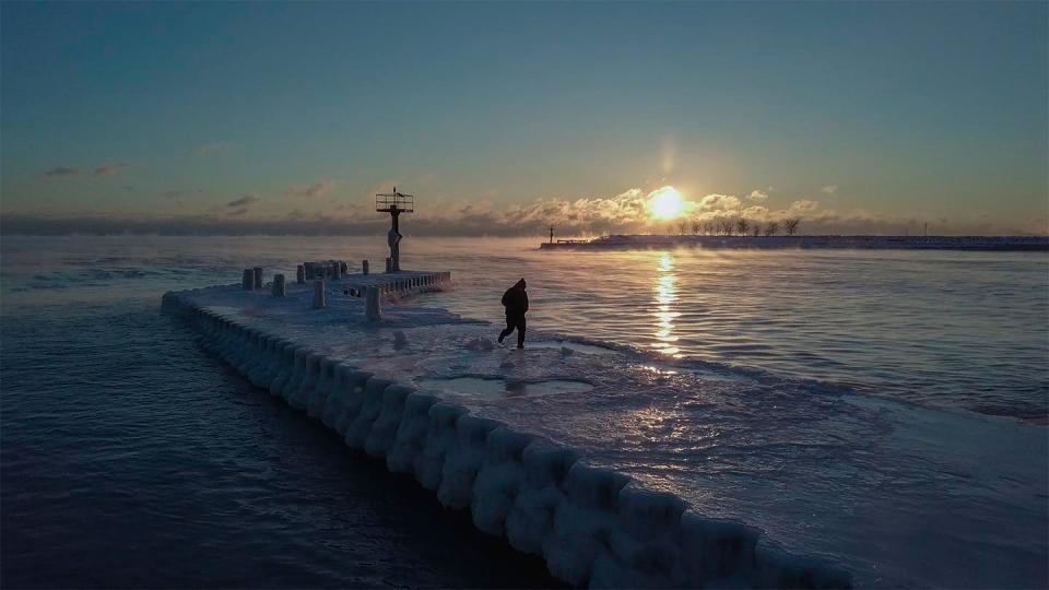  The sun rises, as seen from the 31st Street Beach in Chicago