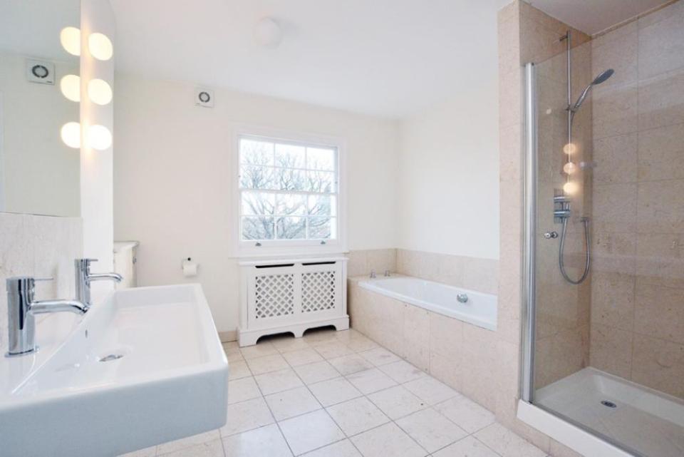  The bathroom contains a walk-in shower and separate bath