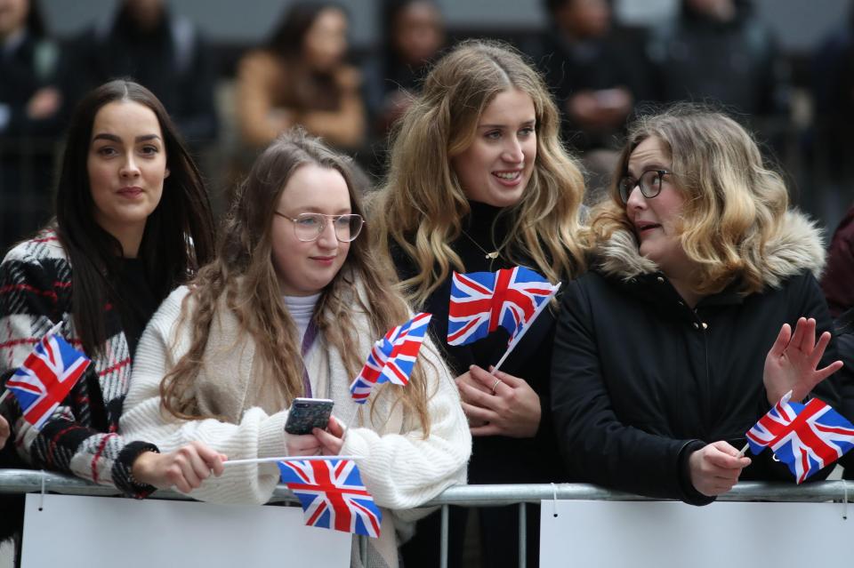  Fans were pictured eagerly awaiting the Duchess of Sussex today