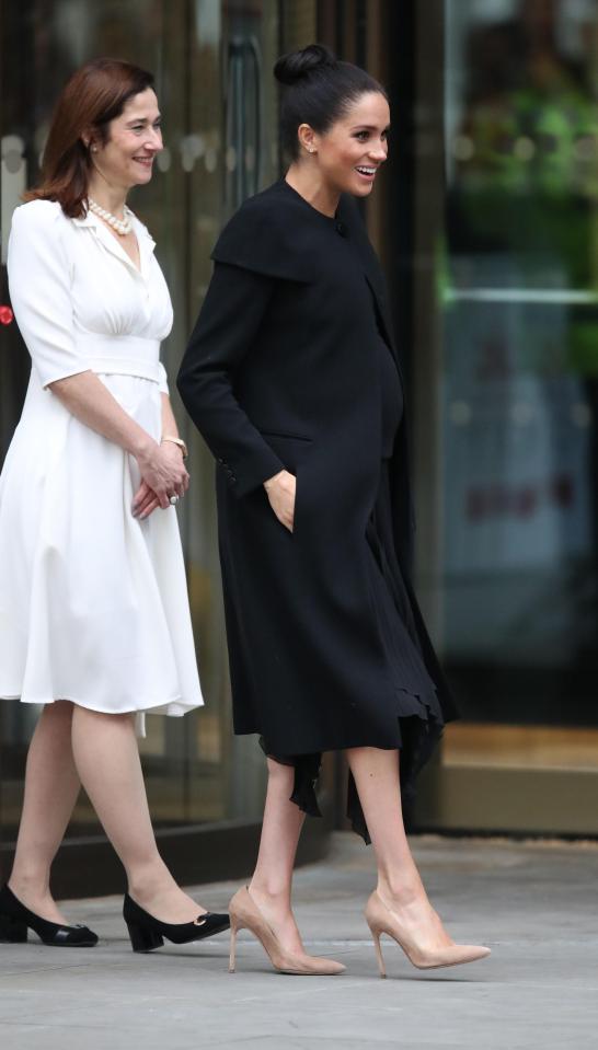  Meghan's growing bump was showing as she visited the University of London today