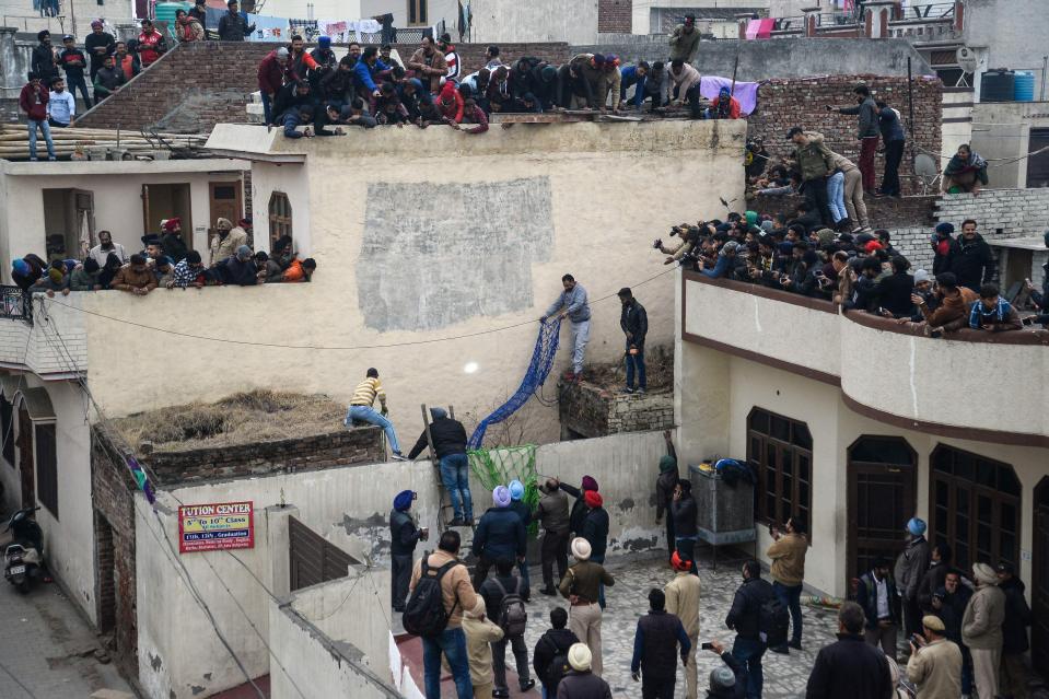  A crowd of more than 100 people watched the leopard as it lashed out at locals