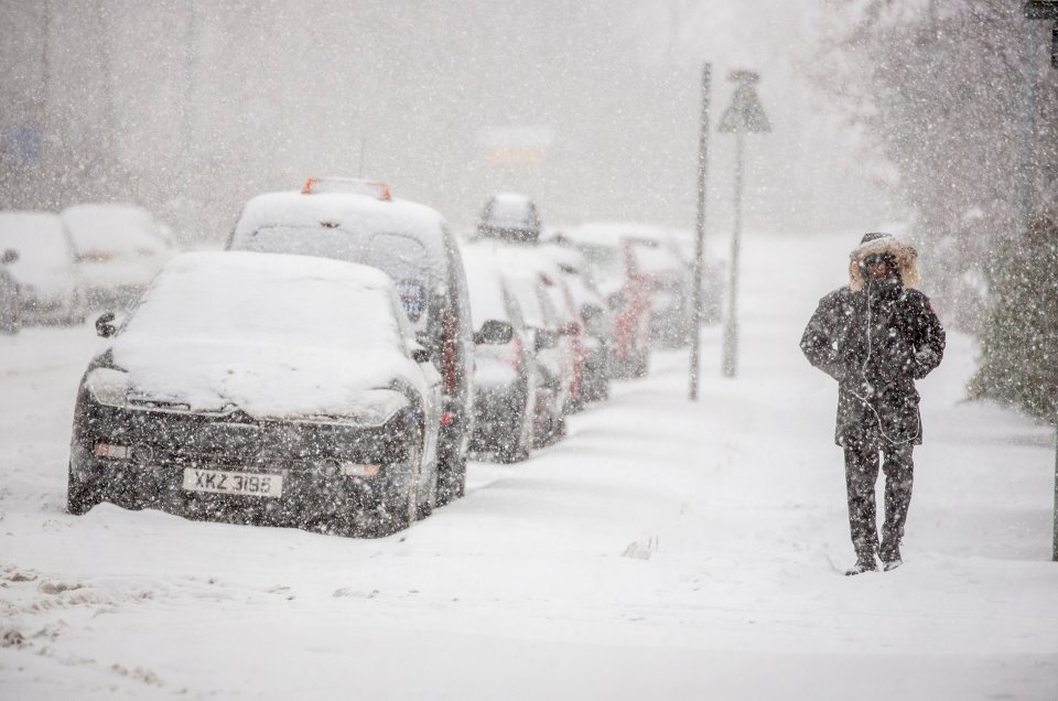  A Londoner braces the heavy snowfall as the Met Office issues an Amber warning across the city