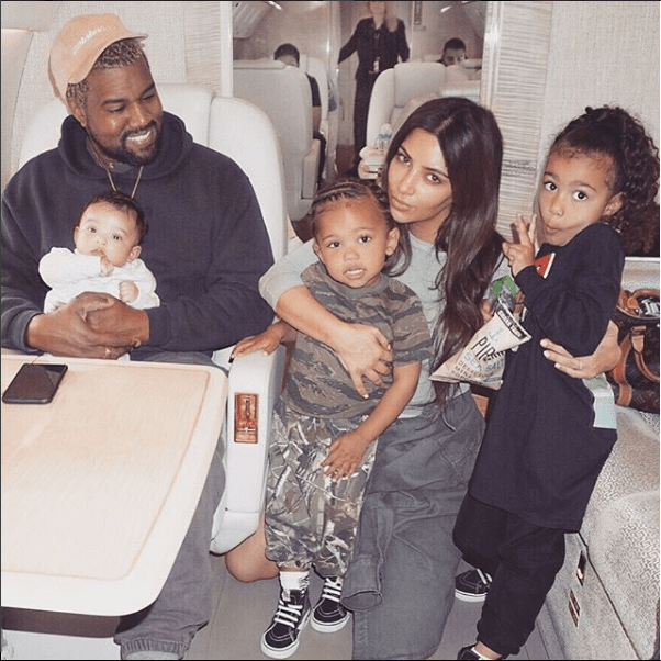  Kanye holding Chicago, while Kim hugs Saint and North