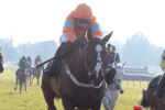 Ted Bach battled through the mud under a cool ride from Paddy Brennan