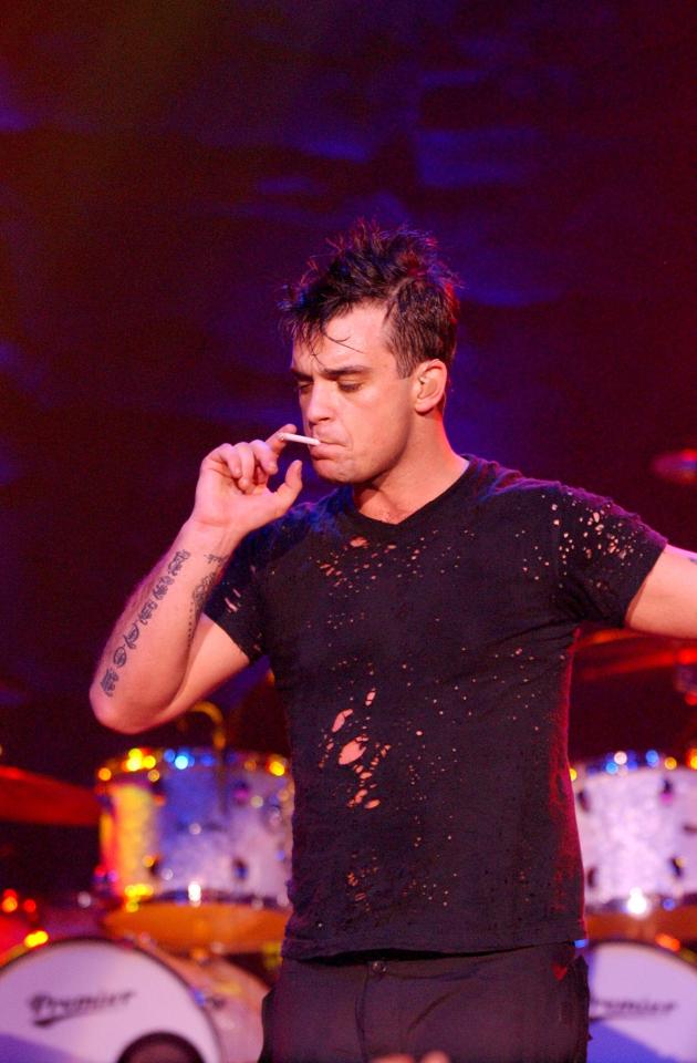  Robbie smoking on stage performing during MTV's Rock The Vote