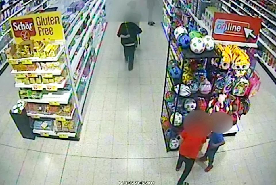  The two boys looking at the footballs within the store immediately before the attack