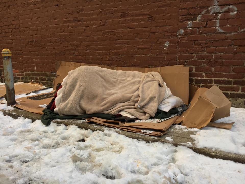  Many homeless face the snow with only cardboard and a sleeping bag for shelter