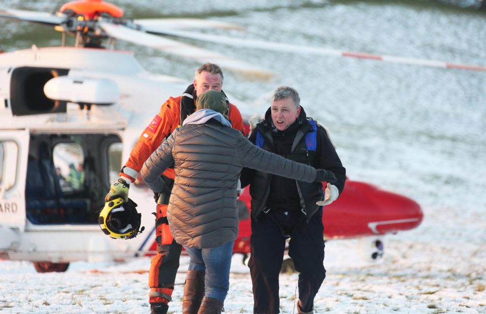  Pilot and rescuer are on the ground and the pilot's relieved wife rushes in