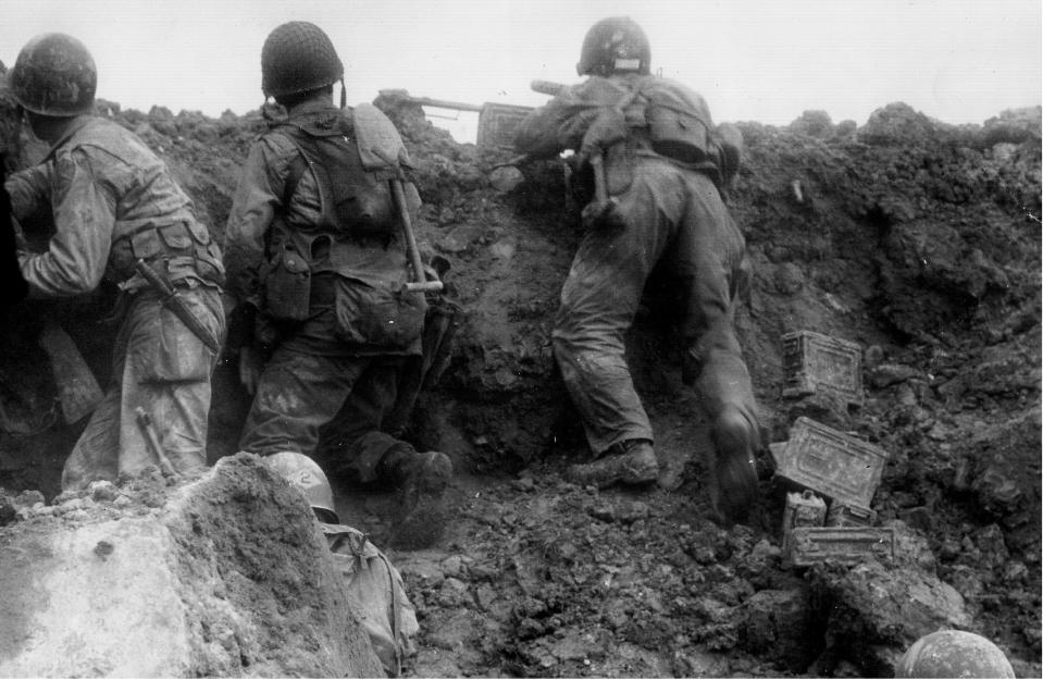  A group from the 2nd Ranger Battalion including a .30 calibre machine gun take up an offensive position early in the Normandy invasion