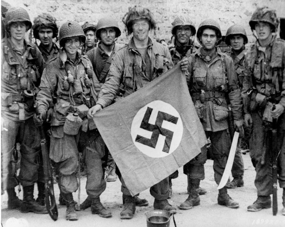  A rifle squad with a captured Nazi flag, one of the prized items sought by troops