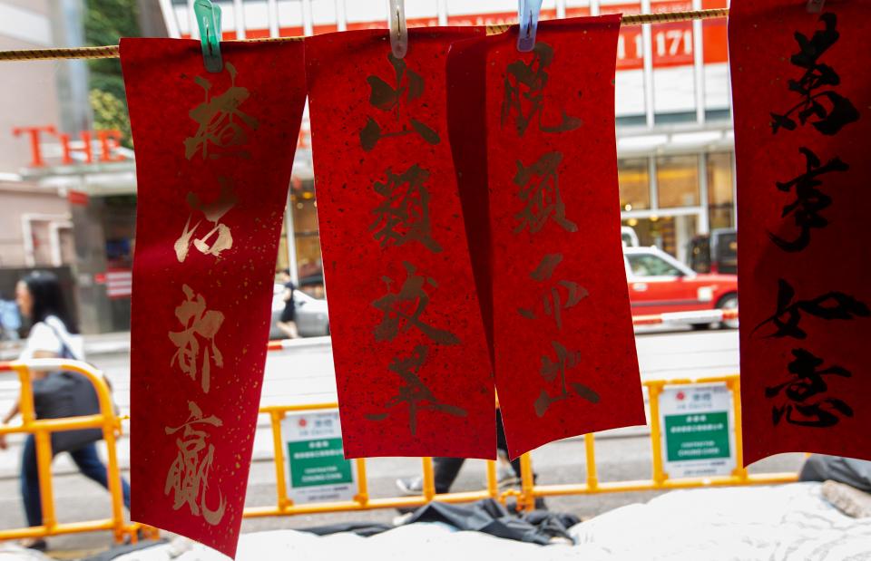  Chinese New Year 'fai chun' calligraphy couplets in gold paint are hung on the front door of houses