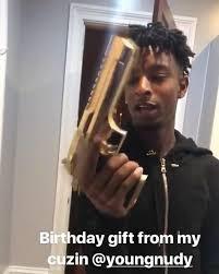  An image posted on Instagram shows the rapper holding a large golden firearm