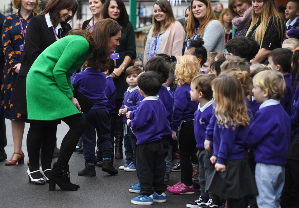  She bent down to speak to the eager schoolchildren waiting to meet her