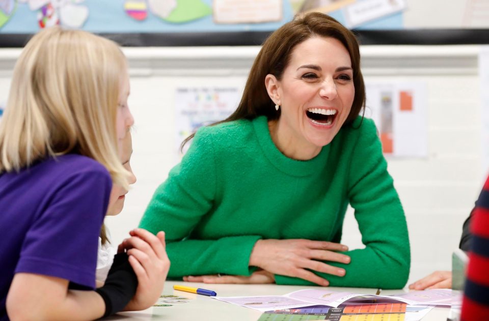  Kate roars with laughter as she talks to pupils in the classroom